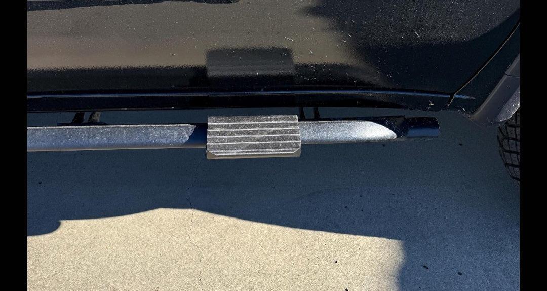 Snap-on sidestep attached to truck side rail on outdoor pavement